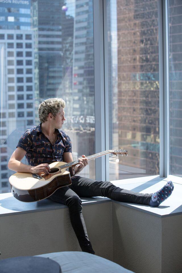 Niall Horan scalzo con la chitarra