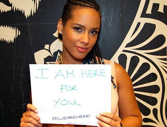 Alicia Keys tiene in mano un cartello della campagna #Wearehere