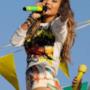 Jennifer Lopez guarda la gente sotto il palco e canta tenendo fra le mani il microfono con i colori del Brasile