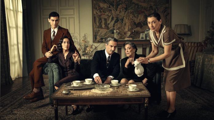 Gli attori della nuova serie Netflix Gli attori di Qualcuno deve morire seduti davanti a un tavolo