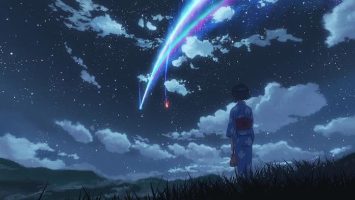 Una scena tratta da Your Name. Una cometa illumina un cielo pieno di stelle, mentre una ragazza guarda la scena