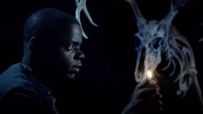 Scappa - Get out, di Jordan Peele (2017) Daniel Kaluuya cammina in un ambente buio con la luce di un accendino