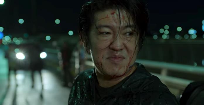 Squid Game: la morte dei protagonisti spiegata Jang Deok-su insanguinato