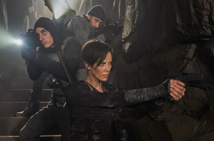 Luca Marinelli e Charlize Theron in due immagini da film precedenti