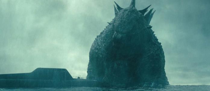 Godzilla Godzilla emerge dal mare al fianco di un sottomarino