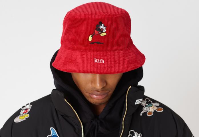 Un modello indossa cappello e cappotto della collezione KITH x Disney