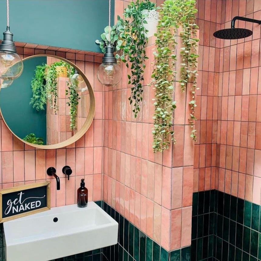 Bagno con piastrelle rosa e nere 