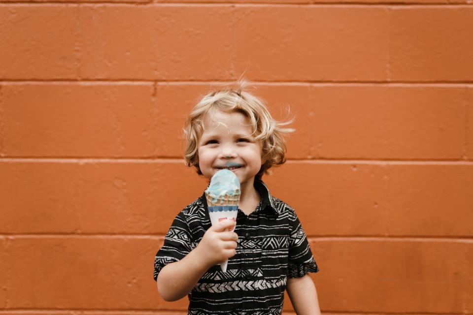 Bambino che mangia da solo un gelato