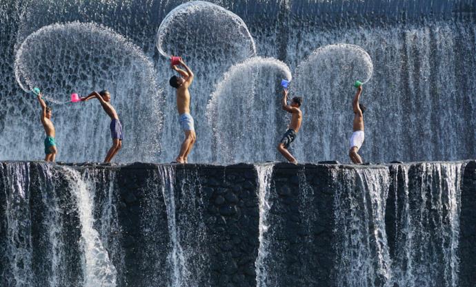 Bali boys playing with water, Indonesia