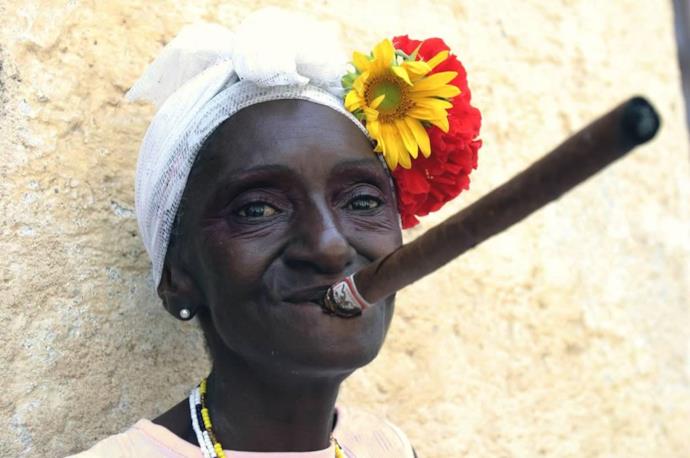 Woman smoking a cigar in Cuba