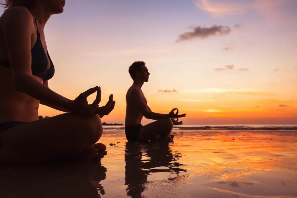 Couple meditating and doing Yoga