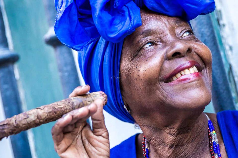 Woman holding a cigar in Cuba