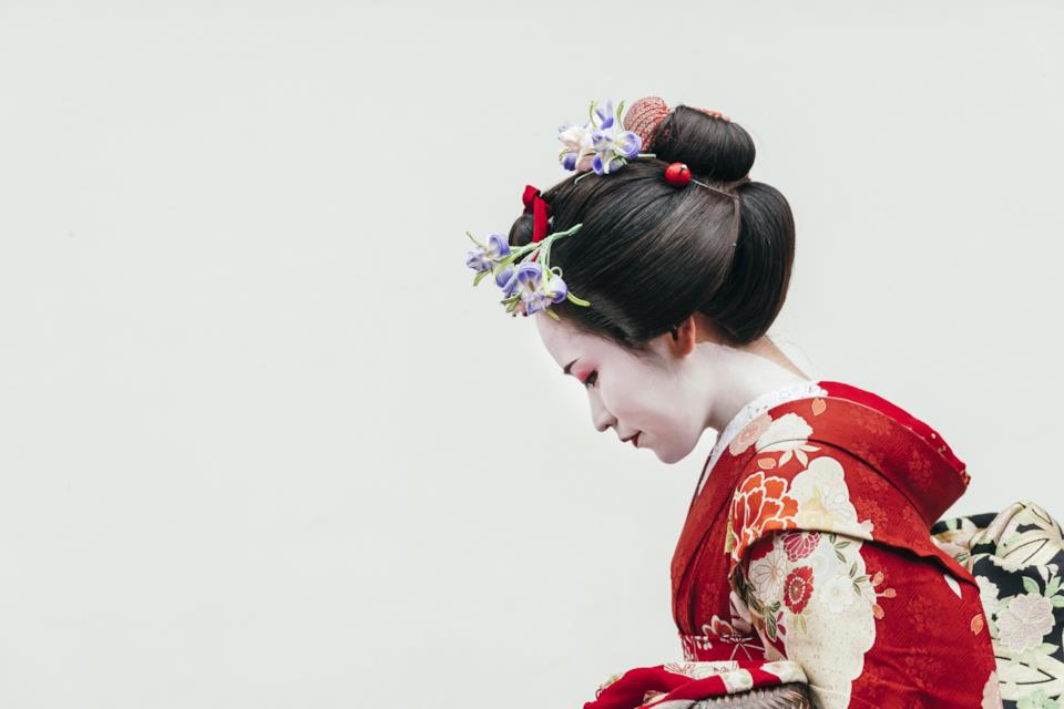 Young geisha or maiko bowing