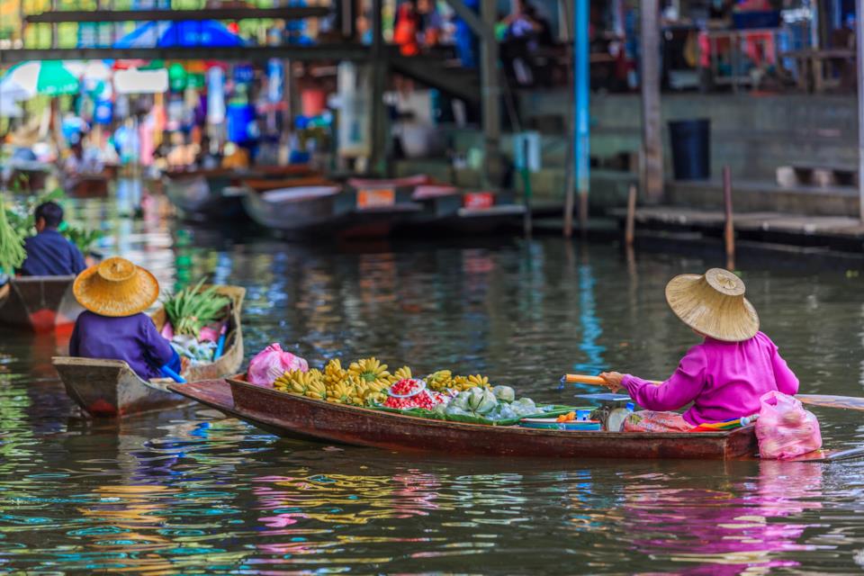 Thai people on boats at a floating market