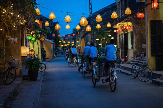 Vietnamese people on bikes in Hoi An