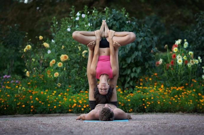 Coppia che pratica AcroYoga, o yoga acrobatico